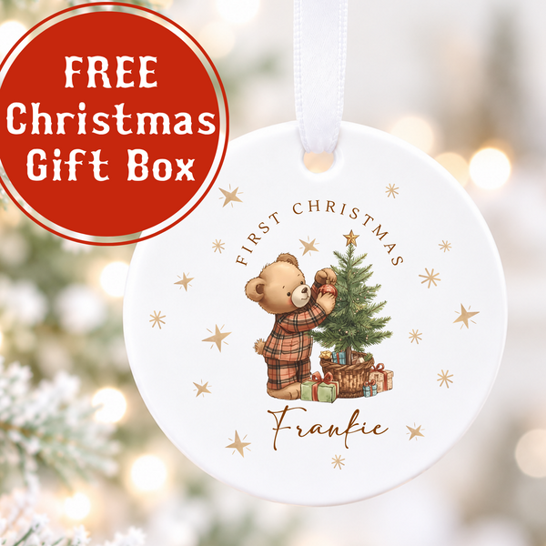 Personalised Baby's First Christmas white ceramic bauble with teddy bear decorating a Christmas tree, gold stars and the name Frankie.