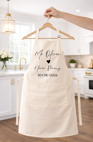 A cream-colored kitchen apron with black personalized text reading 'Mr. Oliver x Never Wrong 30.