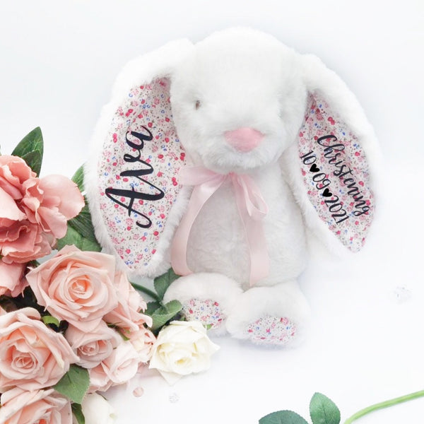 Super cute fluffy white teddy bunny with floral inner ears and black vinyl personalisation saying Ava on one ear and christening and date 