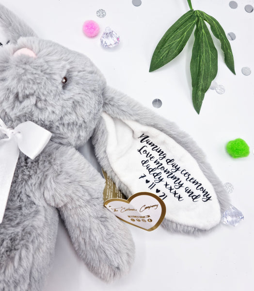 Close up of grey fluffy bunny teddy with white inner ear with black vinyl personalisation