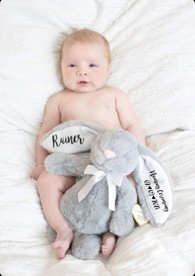 Adorable baby boy cuddling Grey 10" bunny with white inner ears and naming ceremony personalisation  on gift